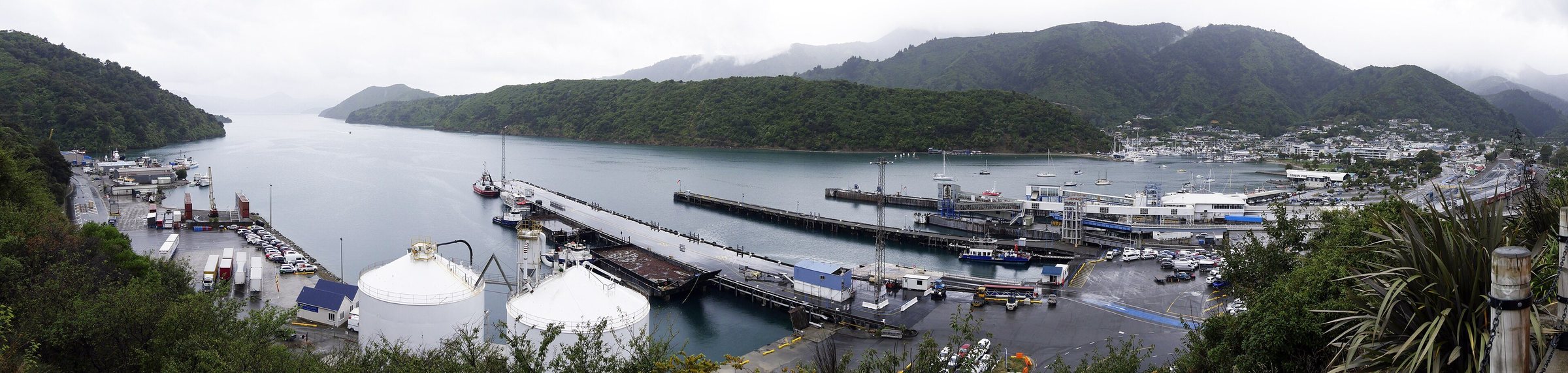 Wide panorama across Picton harbour, the marina berths and the ferry wharves under low cloud