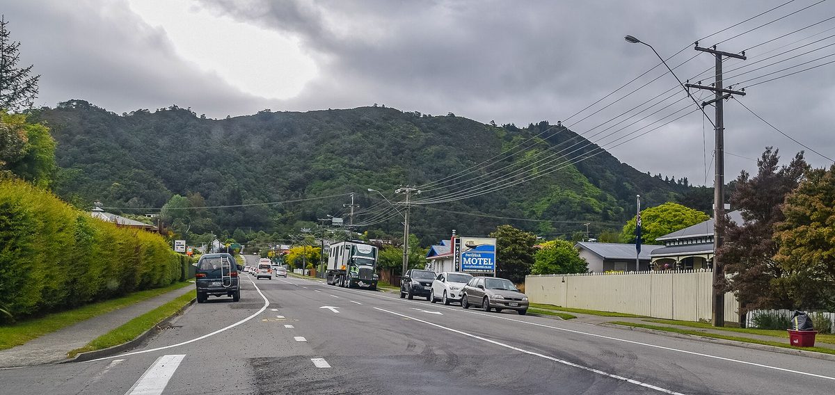 Kent Street in Picton, a wide road into town with parked vehicles and hills in the distance