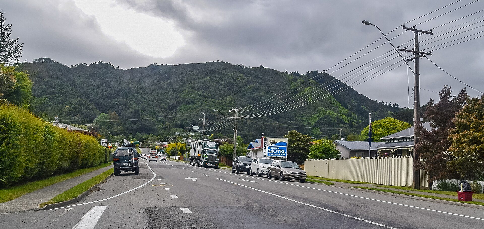 Kent Street in Picton, a wide road into town with parked vehicles and hills in the distance