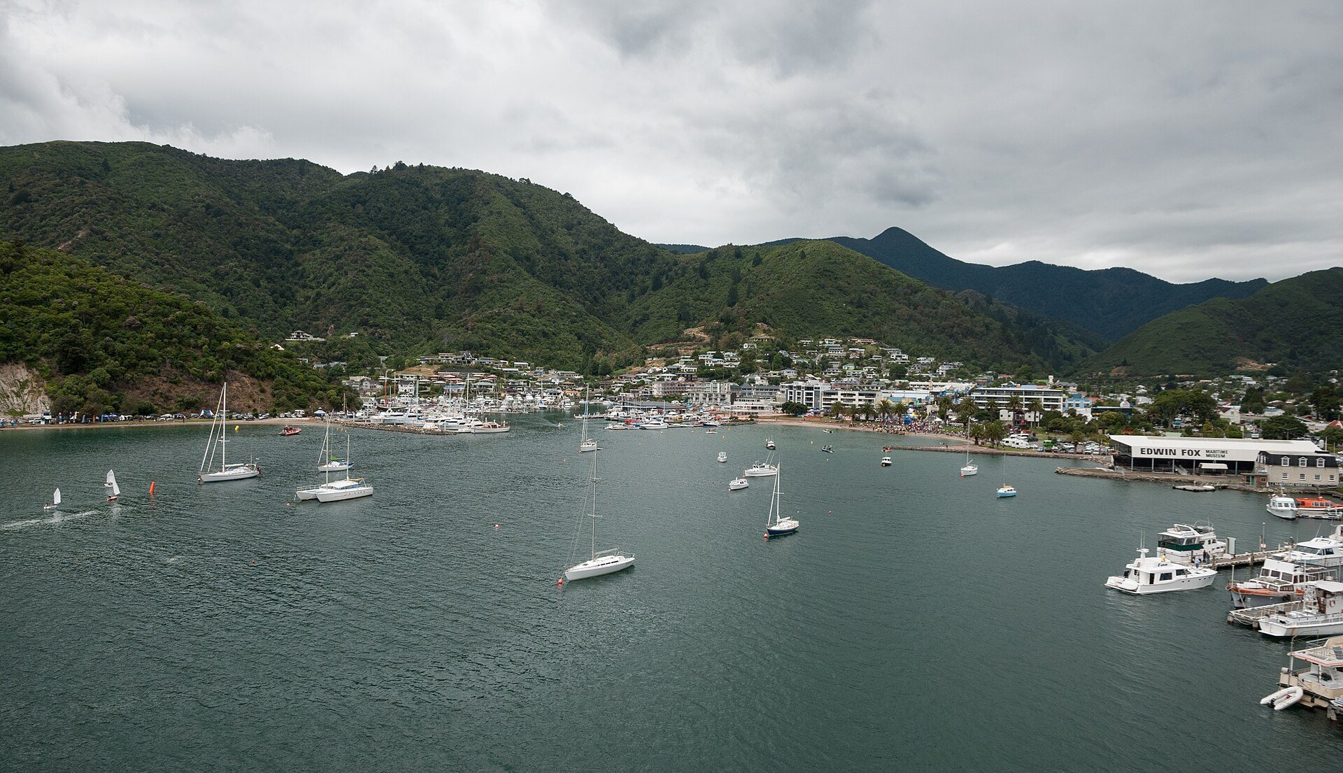 Picton and its marina seen from the water, with yachts moored and the town spread along the shoreline