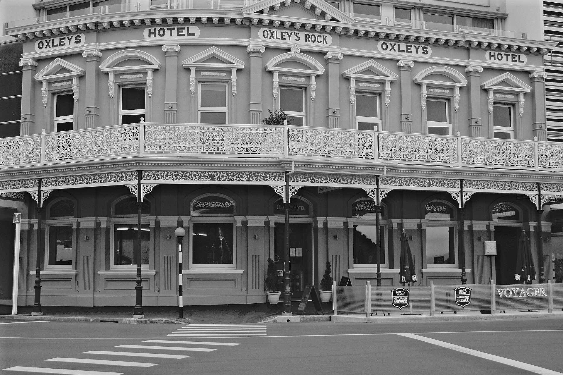 The ornate two-storey Victorian facade of the Oxley's Hotel building in Picton, photographed in black and white