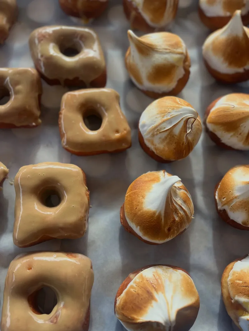 Tray of Only Scoop handmade doughnuts topped with caramel glaze and toasted meringue.