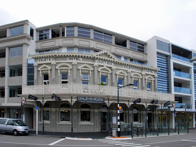 Corner of the Oxley's hotel building with its lacework balcony and Oxley's signs, Picton