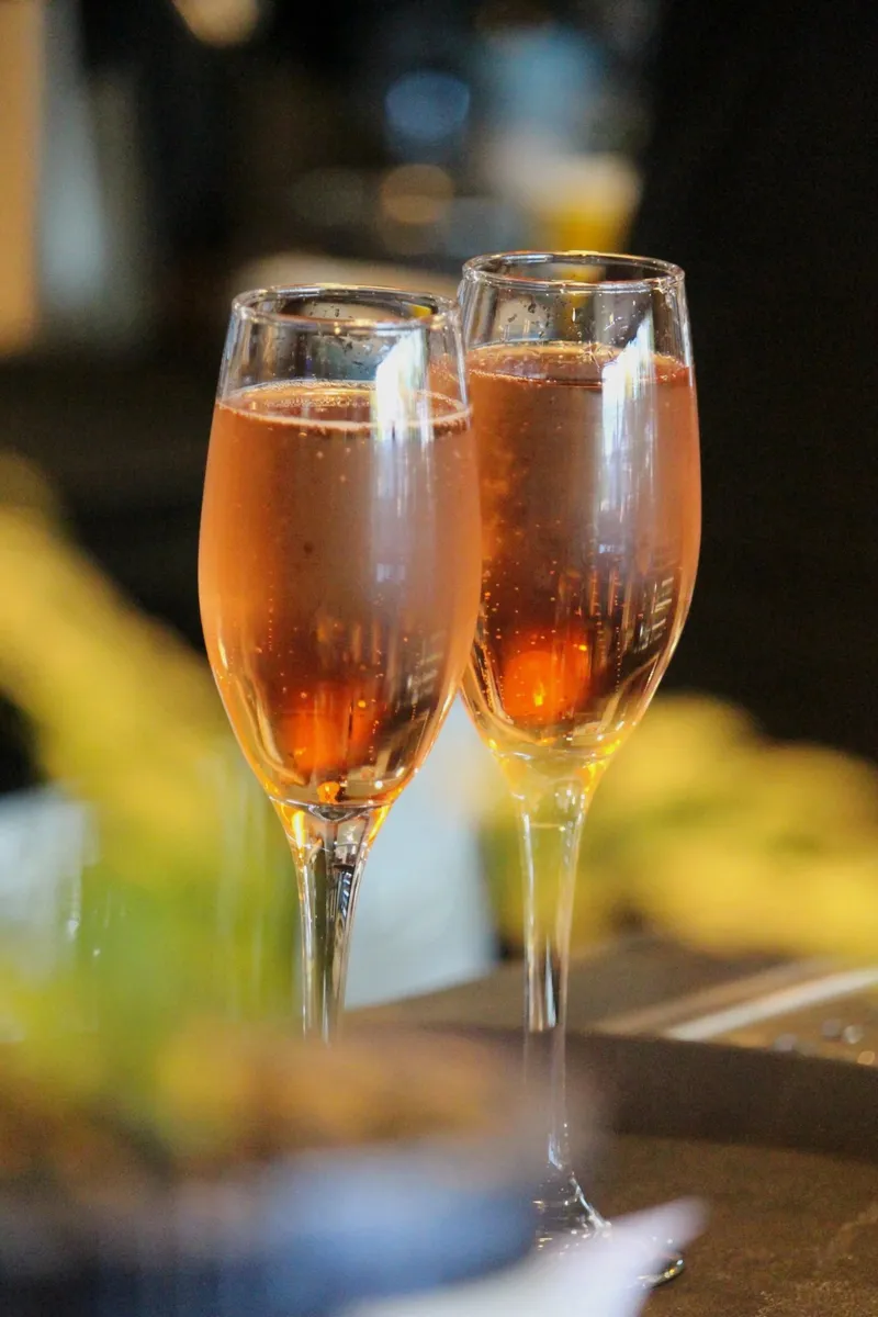Two glasses of sparkling rosé photographed at Sisu's bar.