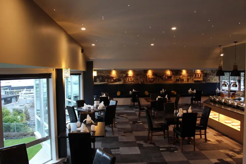 Whalers dining room set with tables, harbour-facing windows and a buffet counter.